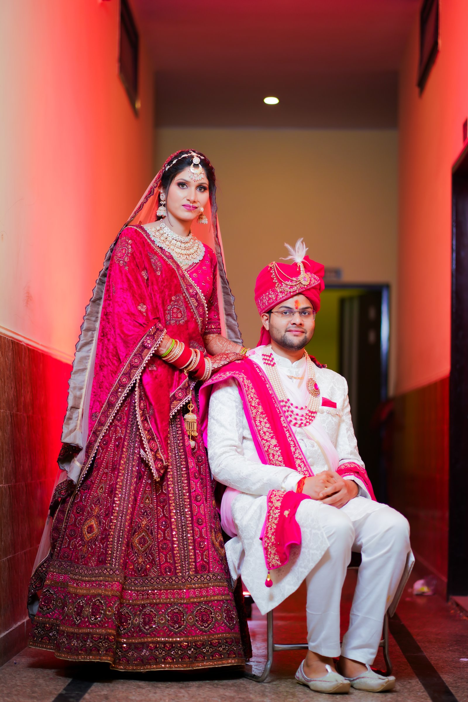 Hariom Singh, lead photographer at Hariom Photography, adjusting a camera at a wedding venue in Bulandshahr